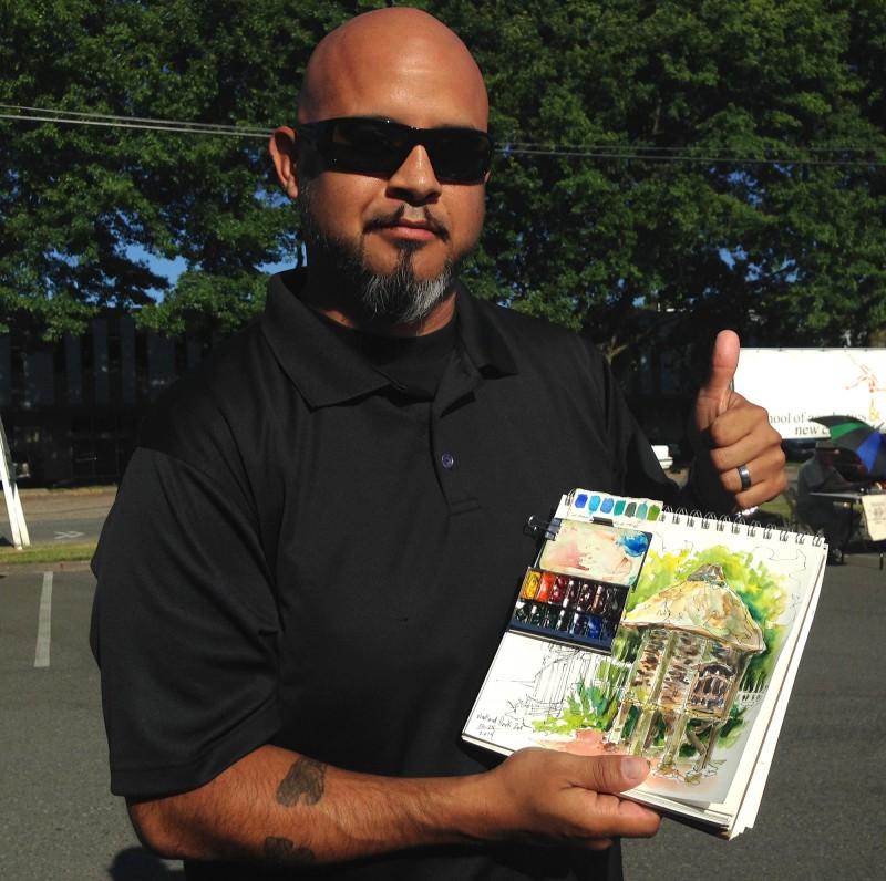 Artist Che Lopez with his Pocket Palette and sketchbook