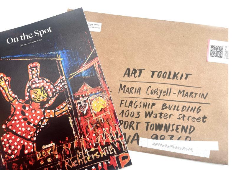A photograph of a magazine cover and hand-addressed envelope.