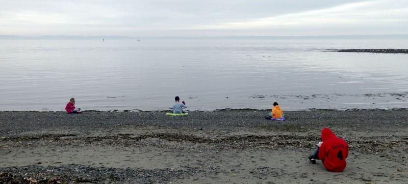 Fifth grade students quietly beach sketching. 